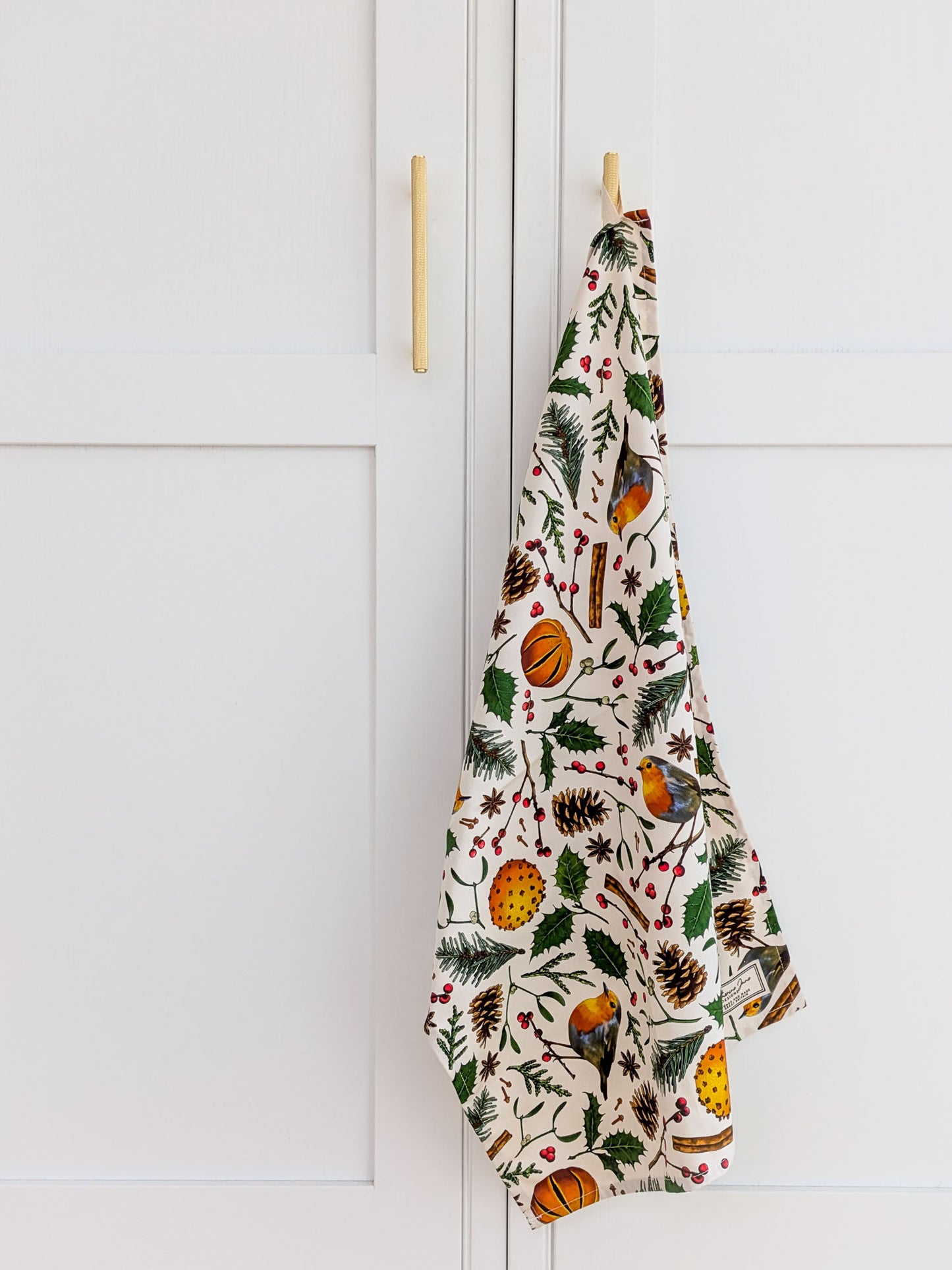 Christmas nature illustrated tea towel hanging in a new inviting kitchen