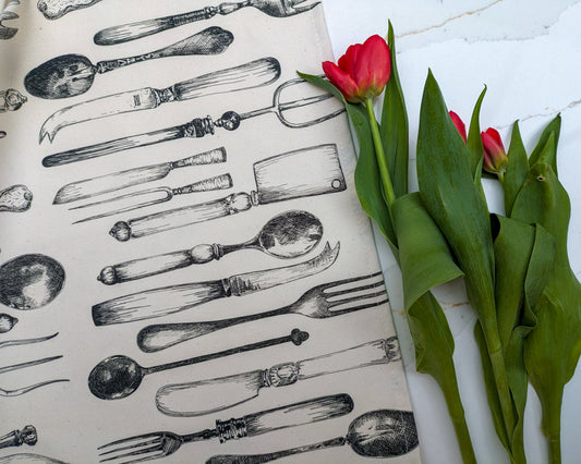 Neutral vintage cutlery illustrated tea towel with fresh cut red tulips