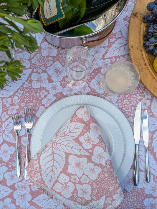 Close up of gorgeous Hydrangea napkin and matching tablecloth with drinks poured and fresh fruit and flowers