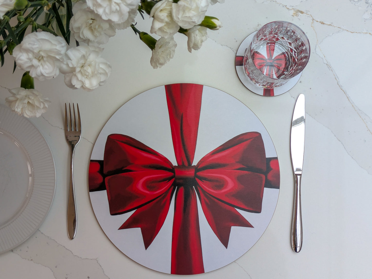 Warm Red ribbon placemat and coaster set shown on a bright marble table with fresh cut flowers, Summer romantic vibes