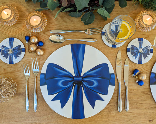 Blue ribbon coaster and placemat set on a laid festive table