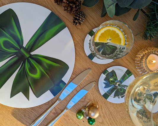 Festive green ribbon placemat and coasters on a laid table