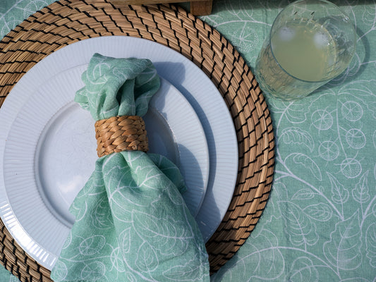 close up of delicate tomato design table cloth and napkin on a laid table