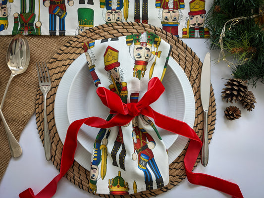 Table set for you with colourful Nutcracker napkin tied with a velvet red ribbon