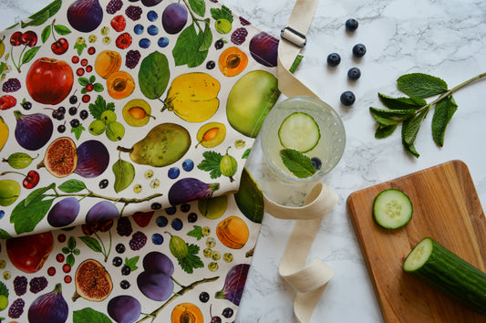 Front view of organic cotton apron with colourful British fruit print by Catherine Jane Designs