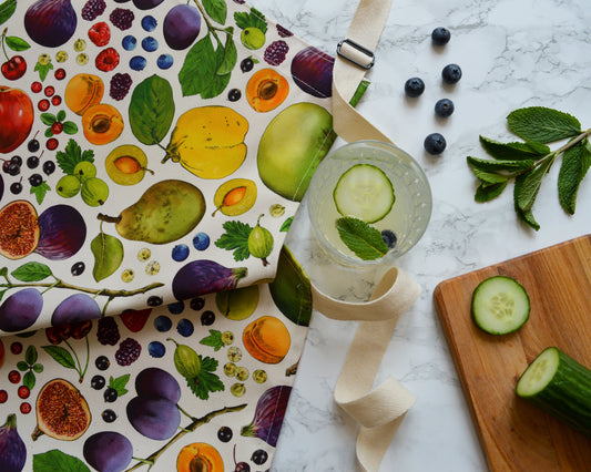 Front view of organic cotton apron with colourful British fruit print by Catherine Jane Designs
