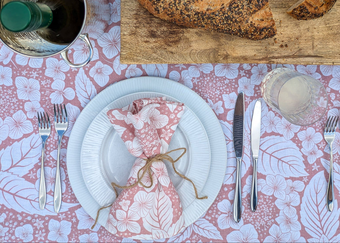 Blooming Hydrangea table cloth and napkin in soft pink on a laid table in summer
