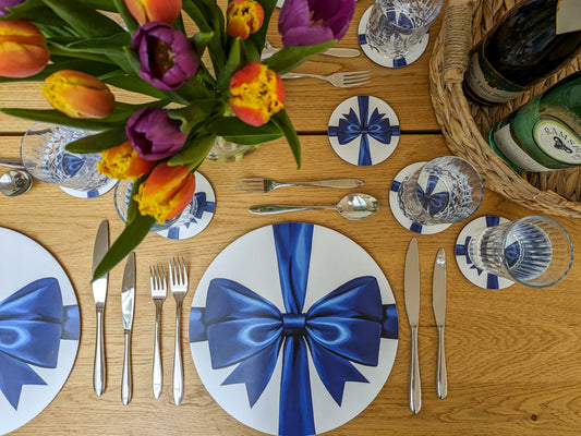 Beautiful spring table with bright blue bow placemats and coasters