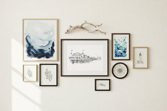 Framed black and white sketch print of Brighton Pier on a white mat, enclosed in a black frame with a seaside inspired gallery wall around 