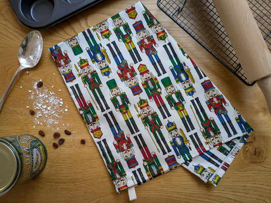 Christmas nutcracker illustrated colourful tea towel pictured with baking equipment