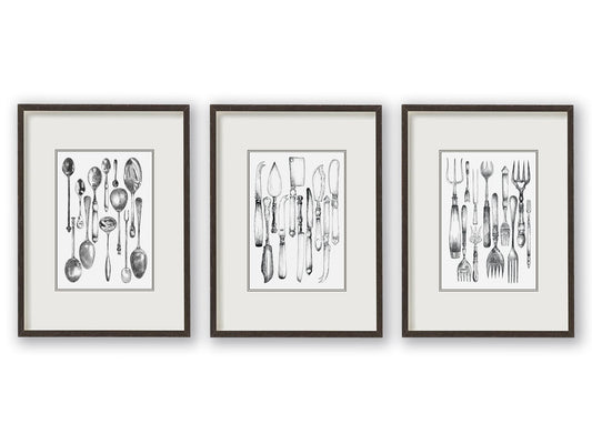 Trio of vintage knife, fork and spoon monochrome illustrations sitting balanced alongside one another, depicted mounted and in black frames