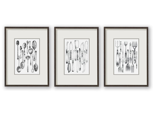 Trio of vintage knife, fork and spoon monochrome illustrations sitting balanced alongside one another, depicted mounted and in black frames