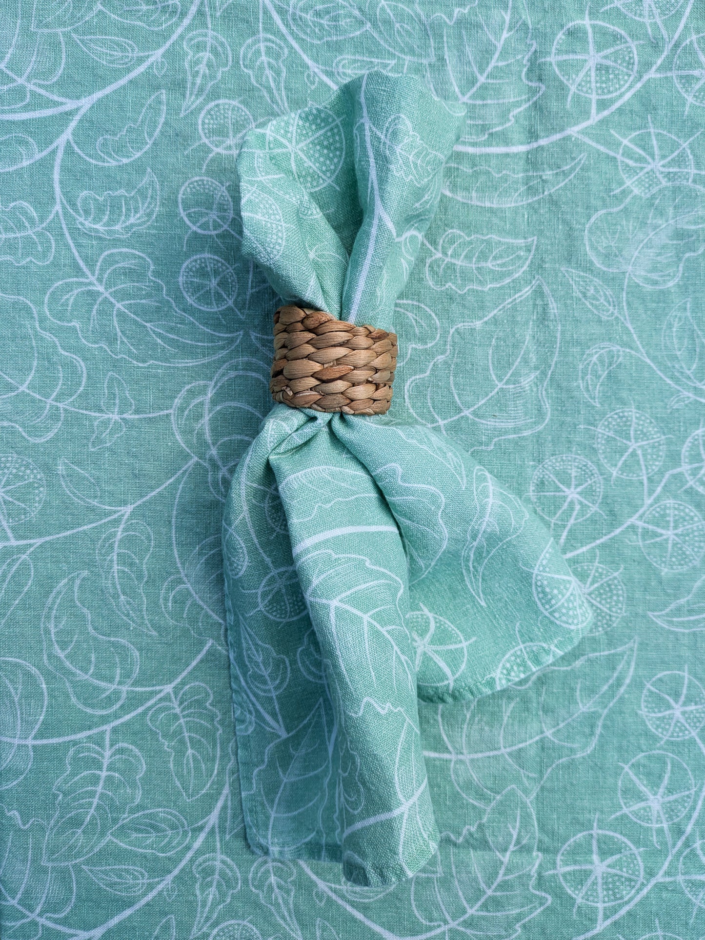 Close up of soft green tomato vine napkin and tablecloth, gorgeous botanical pattern