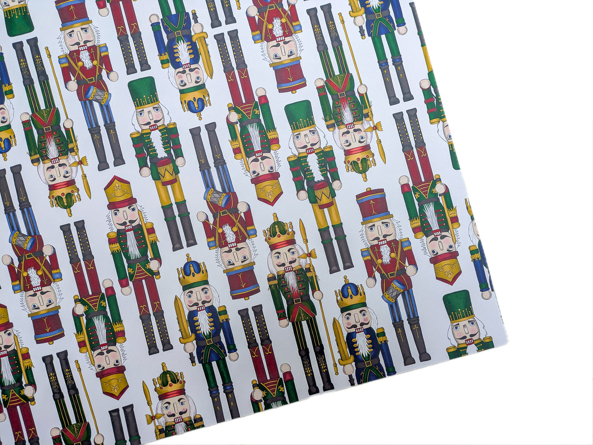Patterned paper with nutcracker design on a white background. Colourful festive design