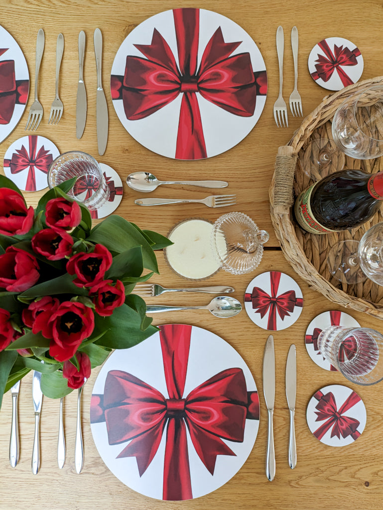 Romantic tablesetting with red ribbon placemats and coasters