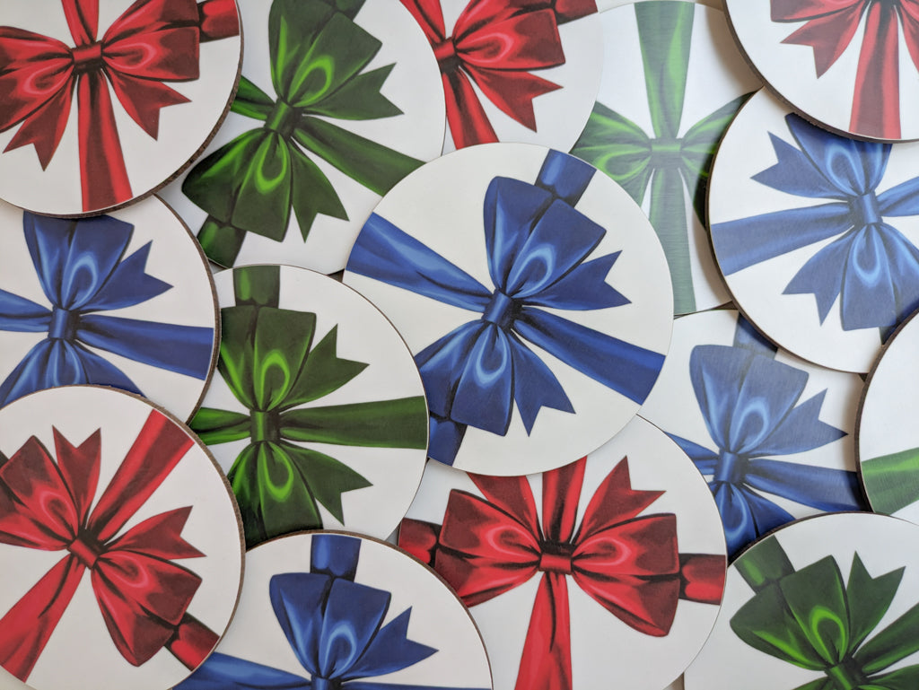 Pile of red, blue and green ribbon coasters