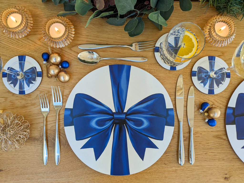 Festive tablescape with electric blue ribbon bow design placemats and coasters