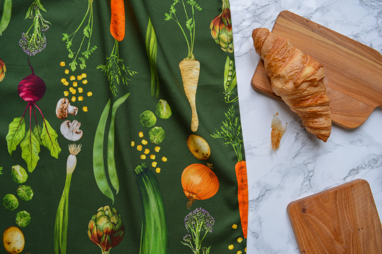 Dark green illustrated tea towel with detailed vegetables