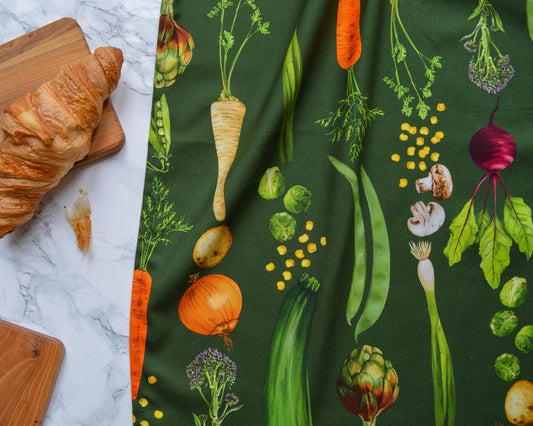 Dark green illustrated tea towel with detailed vegetables
