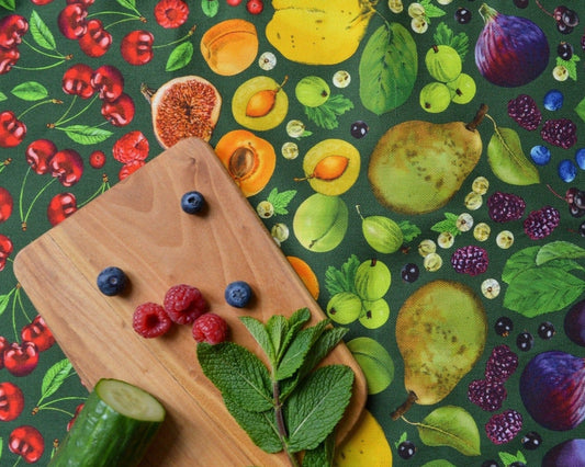Close up of green colourway fruit illustrated cotton tea towel. Gift for foodies