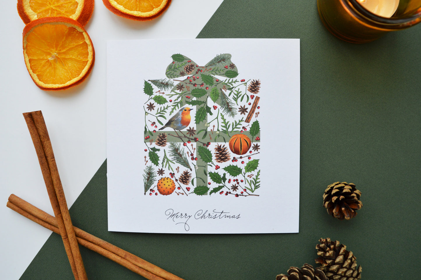 Christmas present card with dried oranges, candle and fir cones