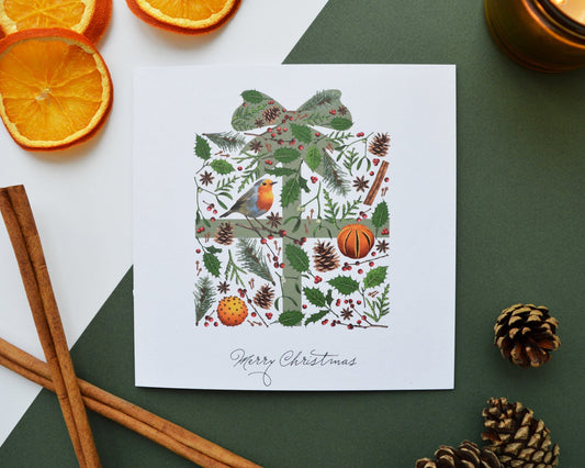 Christmas present card with dried oranges, candle and fir cones