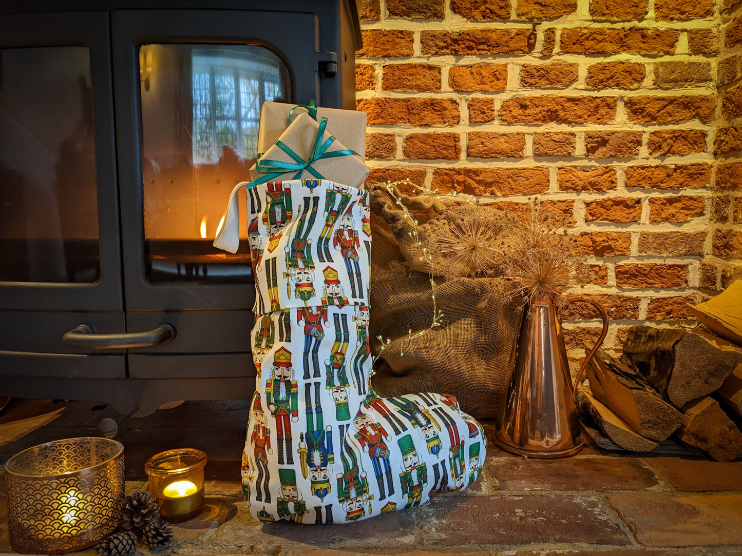 Nutcracker colourful stocking propped up by a lit fire with atmospheric candles and fairy lights