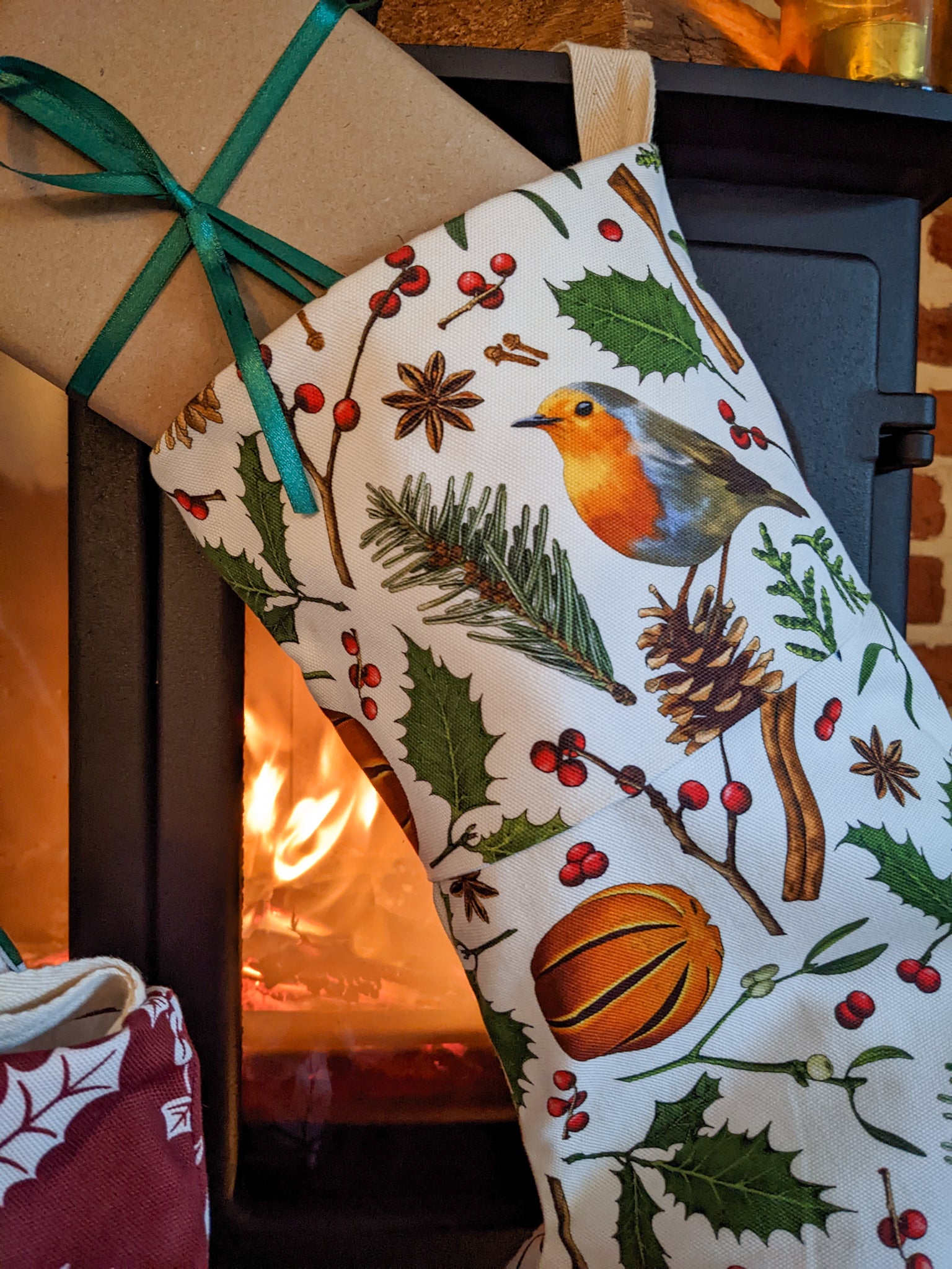 Close up of the nature elements stocking showing pine needles, fir cones, robin, cinnamon sticks, holly and berries