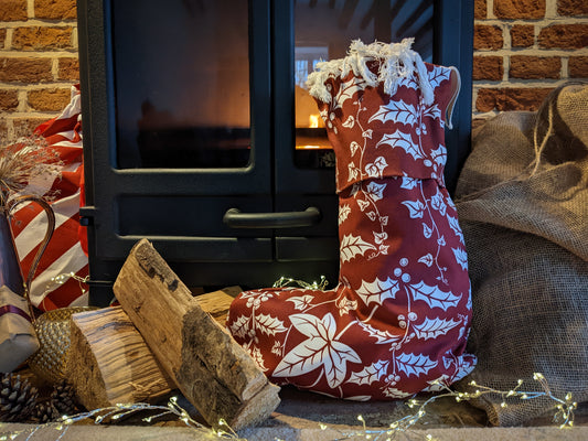 Close up of Christmas stocking filled by the warm fire