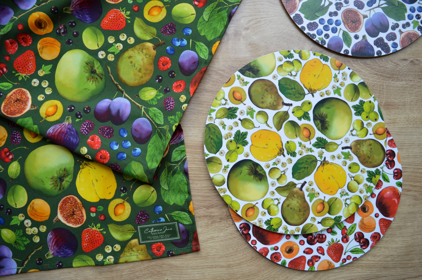 Colourful fruit print tea towel and placemats