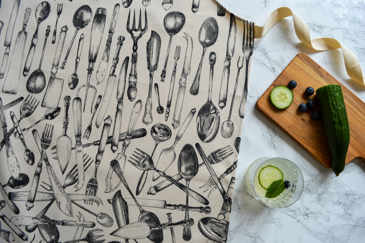 Cutlery apron detail with fresh fruit drink preparation 